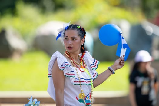 Washington, D.C., USA - September 29, 2018: The Fiesta DC Parade, Woman wearing traditional clothing from Nicaragua going down the street
