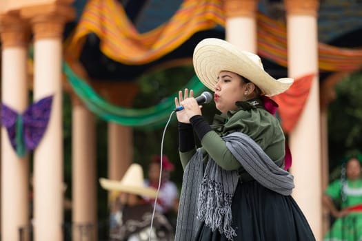 Matamoros, Tamaulipas, Mexico - November 20, 2018: The November 20 Festival, Young woman wearing traditional mexican clothing  singing performing traditional mexican songs