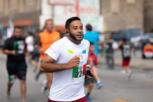 Chicago, Illinois , USA - September 9, 2018, El Grito 5K at la Villita, family run walk, men and women running in the annual 5 kilometers race, prior to the 26th street Mexican Independence Day Parade
