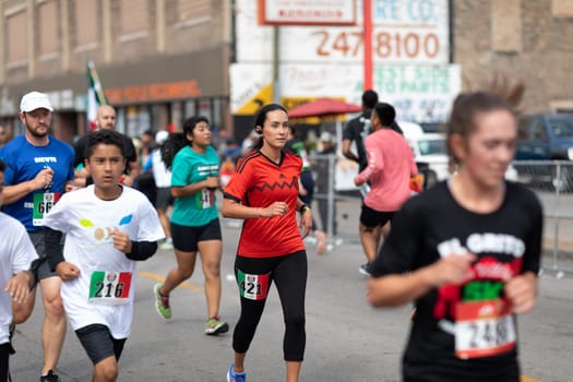 Chicago, Illinois , USA - September 9, 2018, El Grito 5K at la Villita, family run walk, men and women running in the annual 5 kilometers race, prior to the 26th street Mexican Independence Day Parade