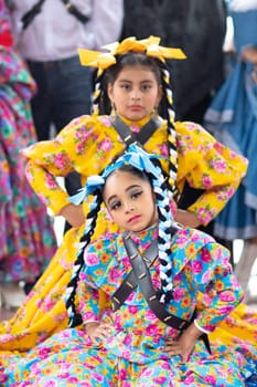 Matamoros, Tamaulipas, Mexico - November 20, 2018: The November 20 Festival, Young men and women wearing traditional mexican clothing, pose for the camera at the Plaza Miguel Hidalgo.