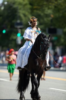 Washington, D.C., USA - September 29, 2018: The Fiesta DC Parade, Woman wearing traditional Panamanian clothing riding a horse
