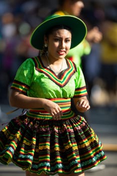 Washington, D.C., USA - September 29, 2018: The Fiesta DC Parade, Bolivian women wearing traditional clothing performing a traditional dance from bolivia
