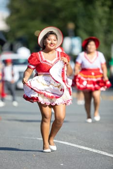 Washington, D.C., USA - September 29, 2018: The Fiesta DC Parade, Bolivian women wearing traditional clothing performing a traditional dance from bolivia
