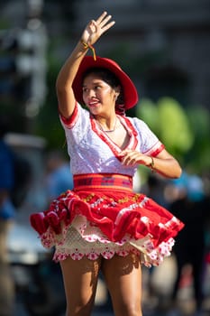 Washington, D.C., USA - September 29, 2018: The Fiesta DC Parade, Bolivian women wearing traditional clothing performing a traditional dance from bolivia