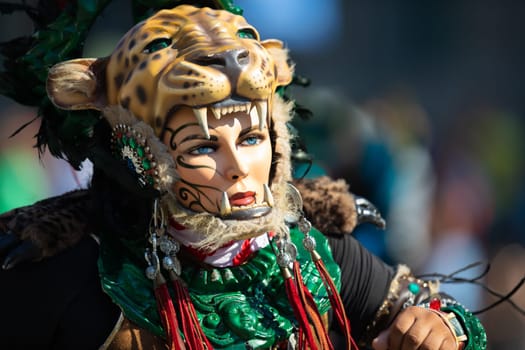 Washington, D.C., USA - September 29, 2018: The Fiesta DC Parade, Men and women from guatemala wearing traditional clothing representing the Indigenous peoples of guatemala wearing abstract mask in shape of a female face with a tiger helmet
