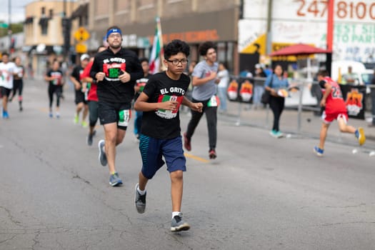 Chicago, Illinois , USA - September 9, 2018, El Grito 5K at la Villita, family run walk, men and women running in the annual 5 kilometers race, prior to the 26th street Mexican Independence Day Parade