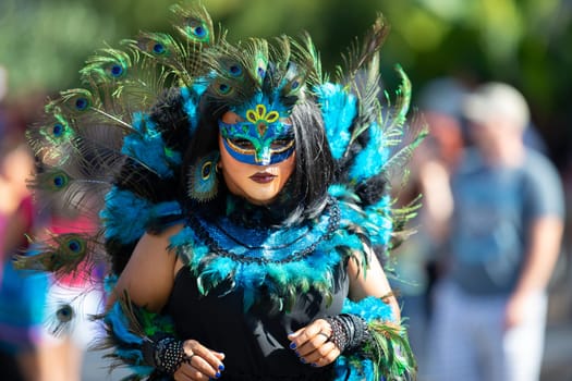 Washington, D.C., USA - September 29, 2018: The Fiesta DC Parade, Men and women from guatemala wearing traditional clothing representing the Indigenous peoples of guatemala wearing abstract mask in shape of a female face with feathers