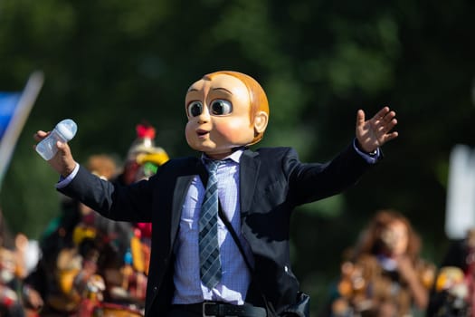 Washington, D.C., USA - September 29, 2018: The Fiesta DC Parade, Guatemalan man dress up as Boss baby, wearing a full face mask