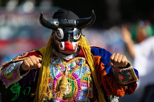 Washington, D.C., USA - September 29, 2018: The Fiesta DC Parade, Men and women from guatemala wearing traditional clothing representing the Indigenous peoples of guatemala wearing abstract mask in shape of a bull