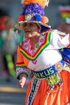 Washington, D.C., USA - September 29, 2018: The Fiesta DC Parade, Bolivian women wearing traditional clothing performing a traditional dance from bolivia