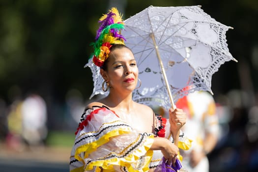 Washington, D.C., USA - September 29, 2018: The Fiesta DC Parade, Mexican woman wearing traditional clothing dancing