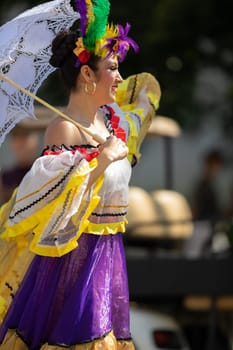 Washington, D.C., USA - September 29, 2018: The Fiesta DC Parade, Mexican woman wearing traditional clothing dancing