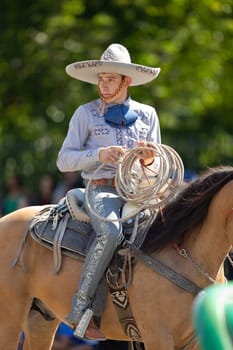 Washington, D.C., USA - September 29, 2018: The Fiesta DC Parade, Man wearing traditional mexican clothing riding a horse