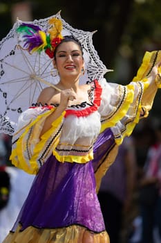 Washington, D.C., USA - September 29, 2018: The Fiesta DC Parade, Mexican woman wearing traditional clothing dancing