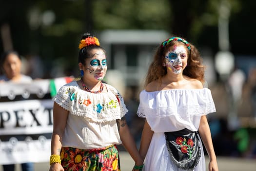 Washington, D.C., USA - September 29, 2018: The Fiesta DC Parade, Mexican woman wearing traditional clothing with face paint as sugar skull