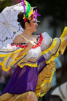 Washington, D.C., USA - September 29, 2018: The Fiesta DC Parade, Mexican woman wearing traditional clothing dancing