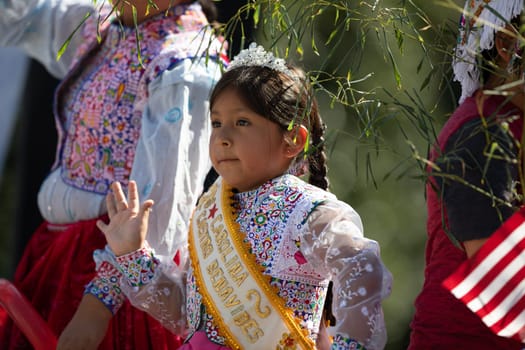 Washington, D.C., USA - September 29, 2018: The Fiesta DC Parade, Peruvian child wearing traditional clothing waving at the spectators