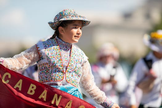 Washington, D.C., USA - September 29, 2018: The Fiesta DC Parade, Peruvian women wearing traditional clothing danicng during the parade