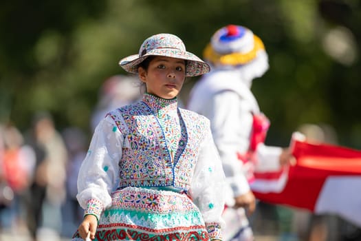 Washington, D.C., USA - September 29, 2018: The Fiesta DC Parade, Peruvian women wearing traditional clothing danicng during the parade