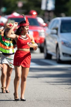 Washington, D.C., USA - September 29, 2018: The Fiesta DC Parade, peruvian woman wearing traditional clothing danicng during the parade