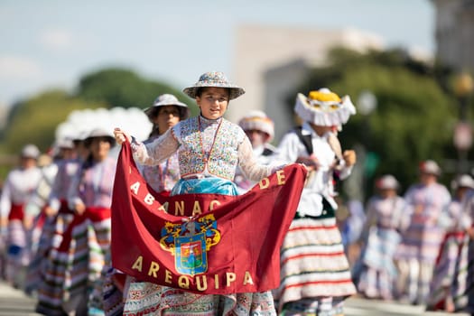 Washington, D.C., USA - September 29, 2018: The Fiesta DC Parade, Peruvian women wearing traditional clothing danicng during the parade