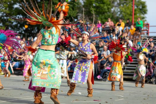 Milwaukee, Wisconsin, USA - September 8, 2018 The Indian Summer Festival: Men women and children members of the Dance Academy of Mexico performing Aztec Dance
