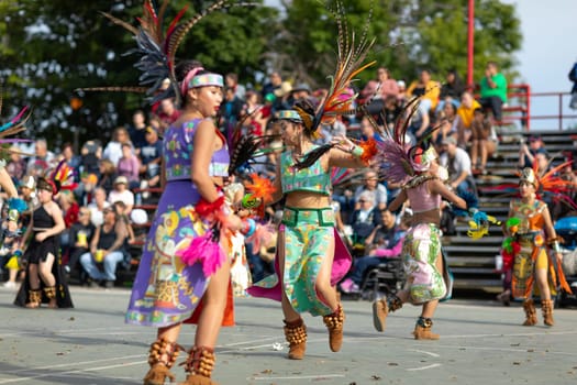 Milwaukee, Wisconsin, USA - September 8, 2018 The Indian Summer Festival: Men women and children members of the Dance Academy of Mexico performing Aztec Dance