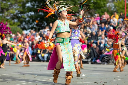 Milwaukee, Wisconsin, USA - September 8, 2018 The Indian Summer Festival: Men women and children members of the Dance Academy of Mexico performing Aztec Dance
