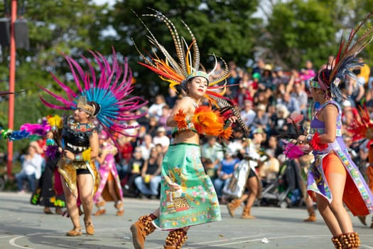 Milwaukee, Wisconsin, USA - September 8, 2018 The Indian Summer Festival: Men women and children members of the Dance Academy of Mexico performing Aztec Dance