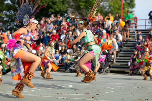 Milwaukee, Wisconsin, USA - September 8, 2018 The Indian Summer Festival: Men women and children members of the Dance Academy of Mexico performing Aztec Dance