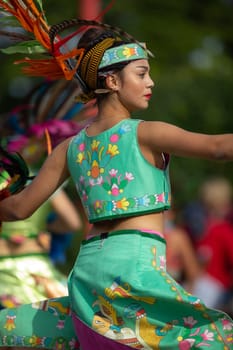 Milwaukee, Wisconsin, USA - September 8, 2018 The Indian Summer Festival: Men women and children members of the Dance Academy of Mexico performing Aztec Dance