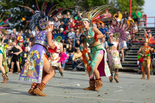 Milwaukee, Wisconsin, USA - September 8, 2018 The Indian Summer Festival: Men women and children members of the Dance Academy of Mexico performing Aztec Dance