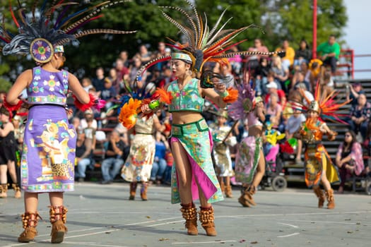 Milwaukee, Wisconsin, USA - September 8, 2018 The Indian Summer Festival: Men women and children members of the Dance Academy of Mexico performing Aztec Dance