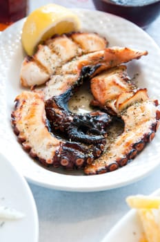 octopus grilled meat on a white plate