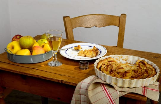 apple pie on a table with apples