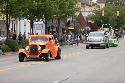 Frankenmuth, Michigan, USA - June 10, 2018 A Hot Rod painted orange with a sticker that says Crush going down the road at the Bavarian Festival Parade.