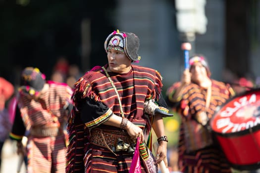 Washington, D.C., USA - September 29, 2018: The Fiesta DC Parade, Bolivian men wearing traditional clothing performing a traditional Bolivian dance