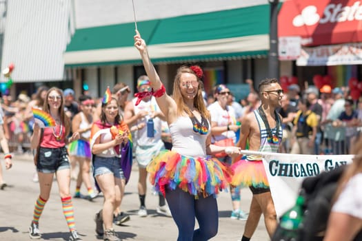 Chicago, Illinois, USA - June 24, 2018 People promoting the Gay Hockey Association, waving the rainbow flag during the LGBTQ Pride Parade in Chicago