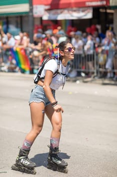 Chicago, Illinois, USA - June 24, 2018 Women on roller skates celebrating during the LGBTQ Pride Parade in Chicago