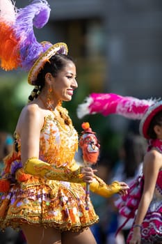 Washington, D.C., USA - September 29, 2018: The Fiesta DC Parade, Bolivian women wearing traditional clothing performing a traditional dance from bolivia