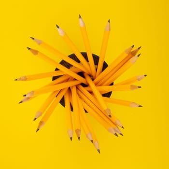 Concept with yellow Pencils on yellow cardboard