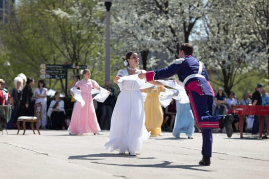 Chicago, Illinois, USA - May 05, 2018 Members of Polonia, polish folk song and dance ensemble, wearing traditional clothing, perform polish traditional dancing at the Grant Park, after the Polish Constitution Day Parade.
