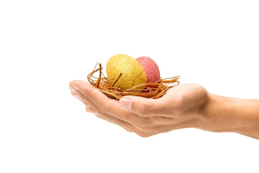 Human hands holding the nest with red and yellow easter eggs isolated over white background. Happy Easter
