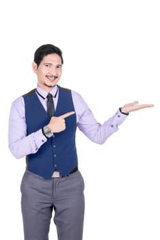 Young asian businessman pointing his open palm posing isolated over white background