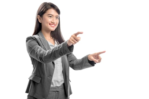 Portrait of asian business woman touching something with her finger posing isolated over white background
