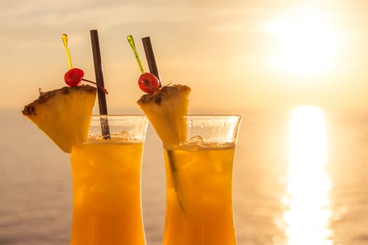 Fresh cool juicy orange pineapple coktails. Perfect wellness drink for enjoyment and relaxation at holiday cruise or vacation travel.