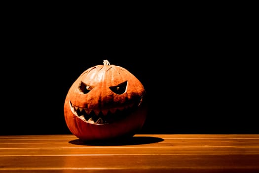 Big spooky helloween symbol has darkest mad face and smiling with sharp teeth and bad look. Black orange nightmare of October 31st.