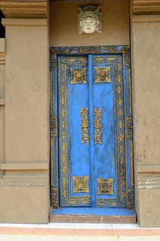 Traditional blue painted front doors of a house in Bali, Indonesia