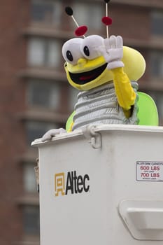 Louisville, Kentucky, USA - May 03, 2018: The Pegasus Parade, Man in a costume in shape of Louie The Lightning Bug, going down the street
